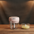 Small food chopper on a wooden table with a dark background